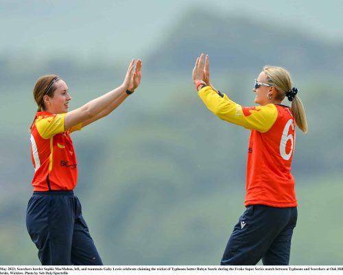 21 May 2023; Scorchers bowler Sophie MacMahon, left, and teammate Gaby Lewis celebrate claiming the wicket of Typhoons batter Robyn Searle during the Evoke Super Series match between Typhoons and Scorchers at Oak Hill Cricket Club in Kilbride, Wicklow. Photo by Seb Daly/Sportsfile